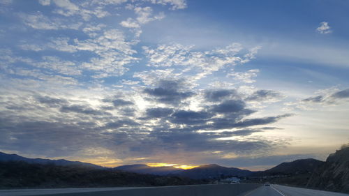Scenic view of mountains against sky at sunset