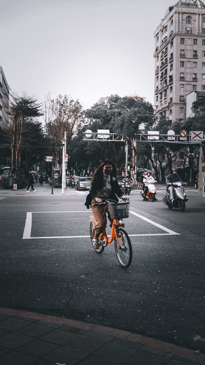 MAN RIDING MOTORCYCLE ON STREET