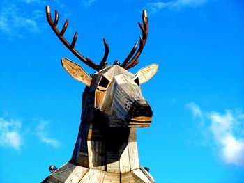 Low angle view of statue against blue sky