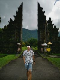 Full length rear view of man standing against sky