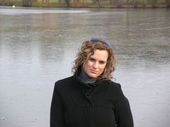 Portrait of beautiful young woman standing in water