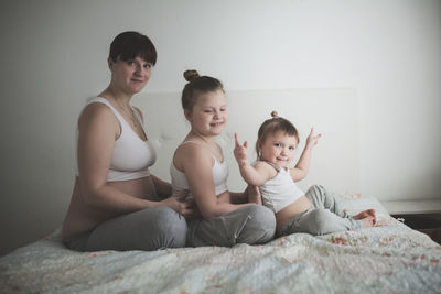 Pregnant mother with daughters, life style in a real interior. the concept of large families 