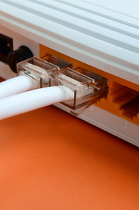 Close-up of computer network cables in router on table