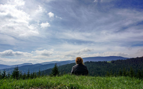 Woman overlooking countryside landscape