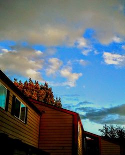 Low angle view of houses against cloudy sky