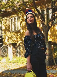 Portrait of woman standing against trees,fall,collors, vintage