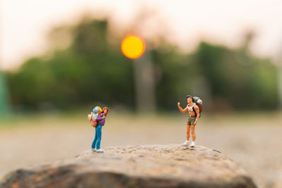 Close-up of figurines on rock