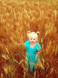 Portrait of smiling girl on field