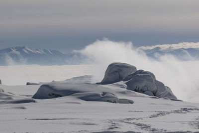 Scenic view of snow covered mountain against sky