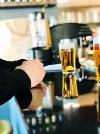 Close-up of hand holding beer glass