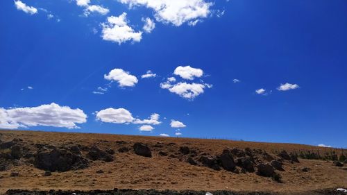 Scenic view of desert against blue sky