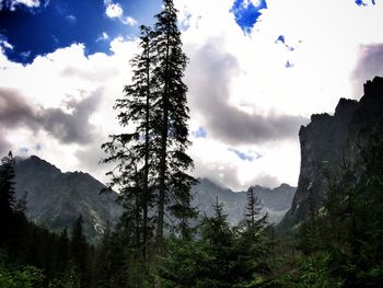 Low angle view of mountain against cloudy sky