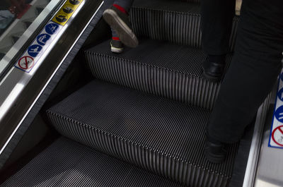 Low section of people on escalator