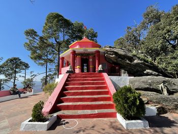 Red temple against sky