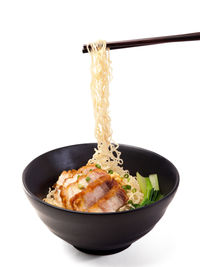 Close-up of food served in bowl against white background