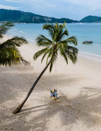 People on beach against sky