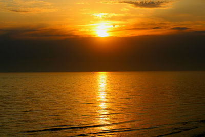 Scenic view of sea against orange sky