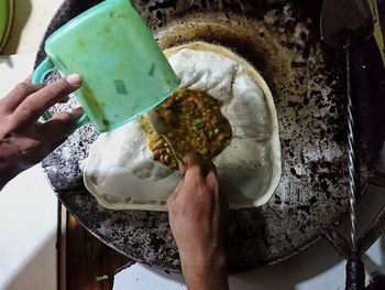 High angle view of man preparing food in kitchen