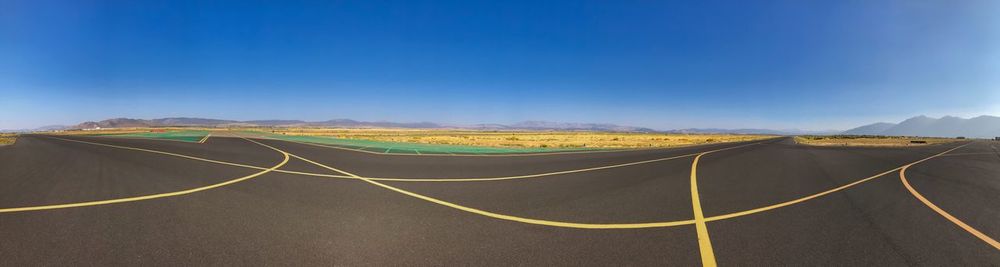 Panoramic view of landscape against blue sky