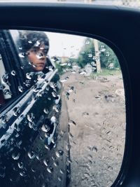 Portrait of man seen through car window