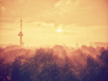 View of buildings against cloudy sky during sunset