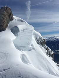 Scenic view of snow covered mountain against sky
