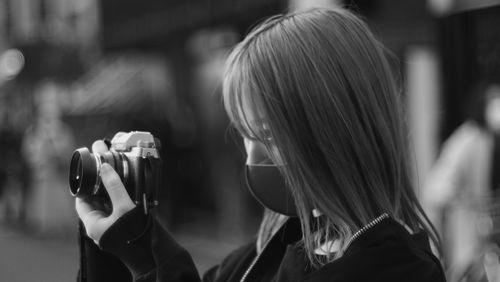 Portrait of woman photographing