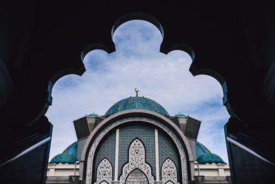 Low angle view of cathedral against cloudy sky