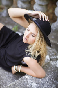 Portrait of young woman sitting outdoors