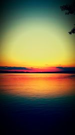 Scenic view of sea against dramatic sky during sunset