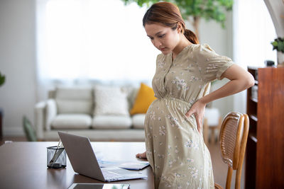 Woman using mobile phone at home