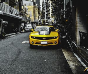 Yellow car on city street