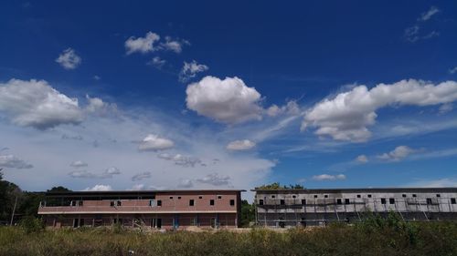 Houses and buildings against blue sky