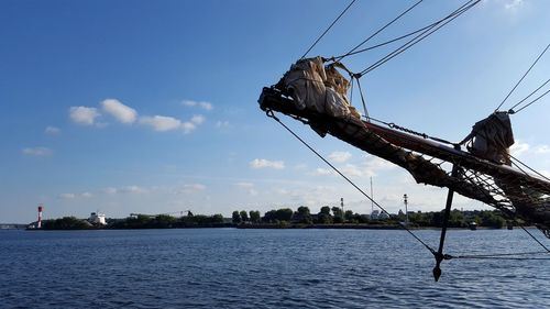 Low angle view of ship by sea against sky