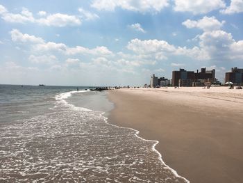 Scenic view of beach against sky in city