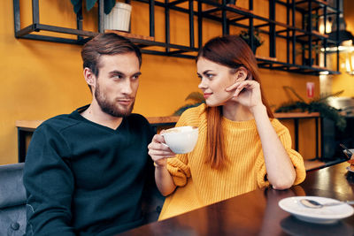 Young woman drinking glasses on table at cafe