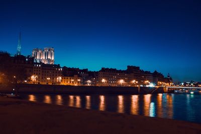 Illuminated city at waterfront