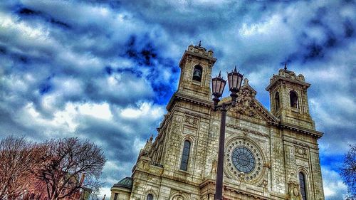 Low angle view of church against cloudy sky