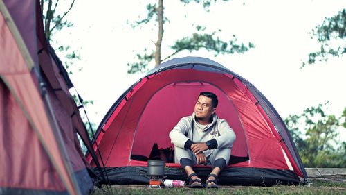 Full length of man sitting in tent