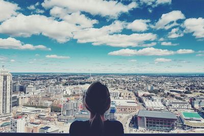 Rear view of woman looking at cityscape