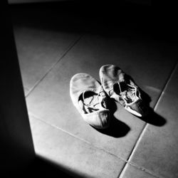 Low section of man on tiled floor