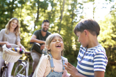 Smiling kids with parents in background