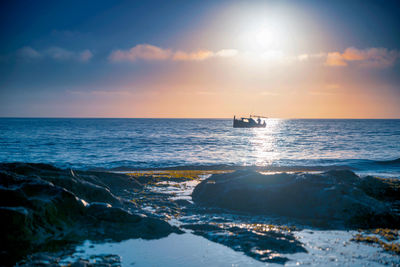 Scenic view of sea against sky during sunrise 