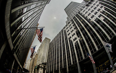 Low angle view of modern buildings in city against sky