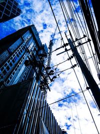 Low angle view of cables against blue sky