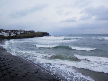 Scenic view of sea against cloudy sky