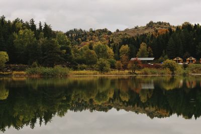 Reflection of trees in lake against sky