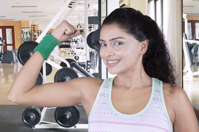 Confident woman exercising in gym