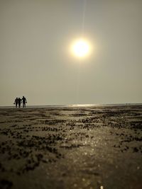 Scenic view of beach against sky during sunset