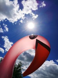 Low angle view of umbrella against bright sun